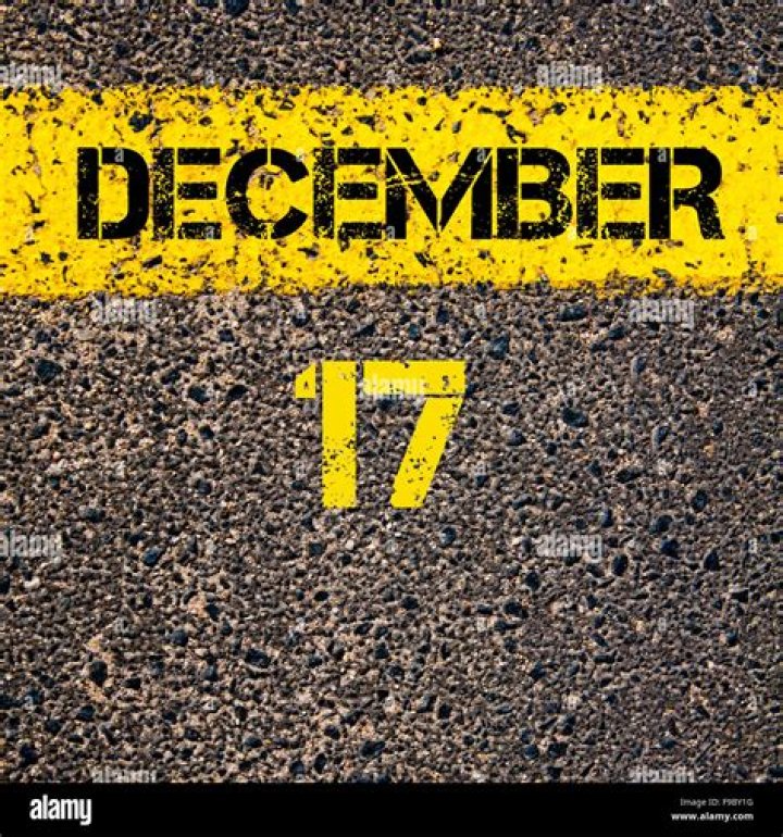 17 December calendar day written over road marking yellow paint line