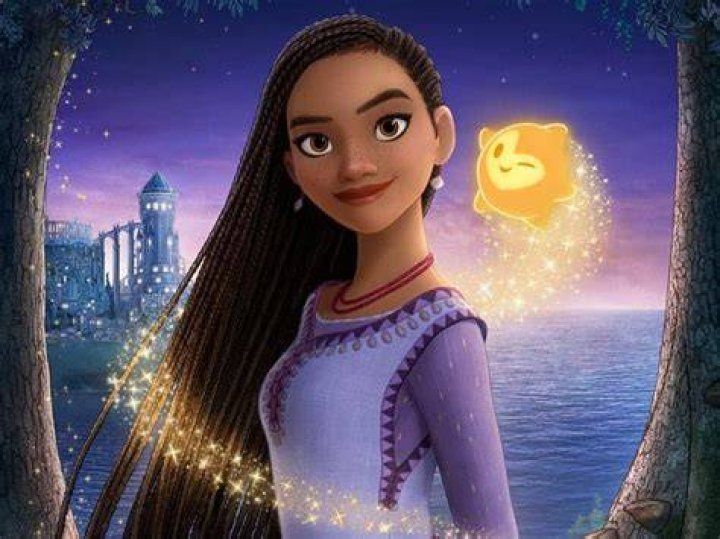 Asha's braids blow in the wind as she looks up at the night sky in Disney's Wish.