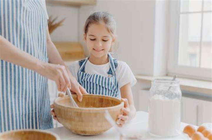 Domestic helper cooks tasty pap and cabbage meal for family