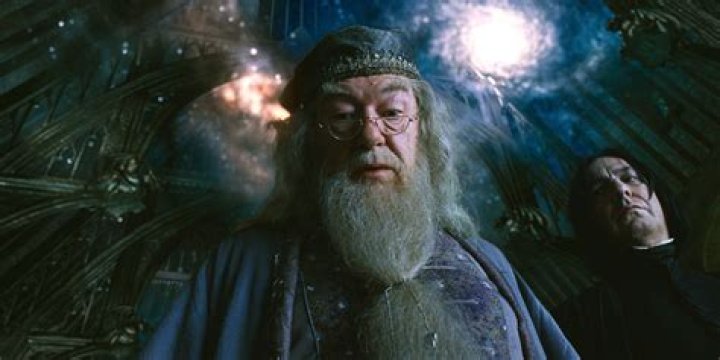 Dumbledore holding up his hand in Fantastic Beasts The Secrets of Dumbledore