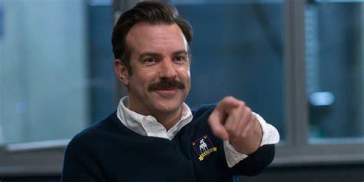 Jason Sudeikis as Ted Lasso and Hannah Waddingham as Rebecca