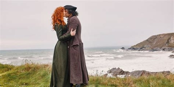 Ross and Demelza kiss on the cliffside in Poldark
