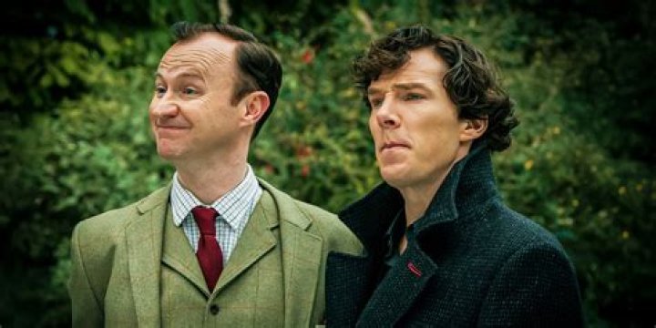 Sherlock & Watson stand in front of door in Sherlock