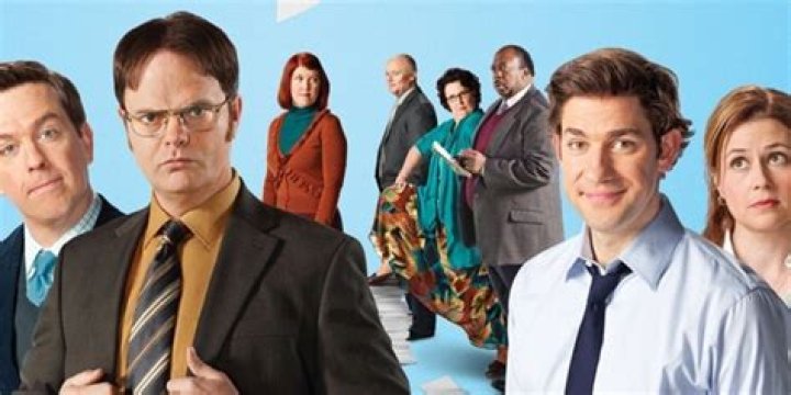 The Office cast pose in front of a Christmas tree