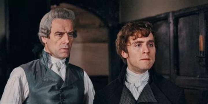 Two men look on blankly in Poldark